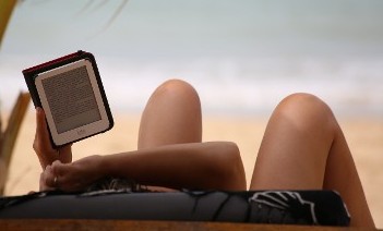 Someone Using a Tablet on the Beach Someone Using a Tablet on the Beach